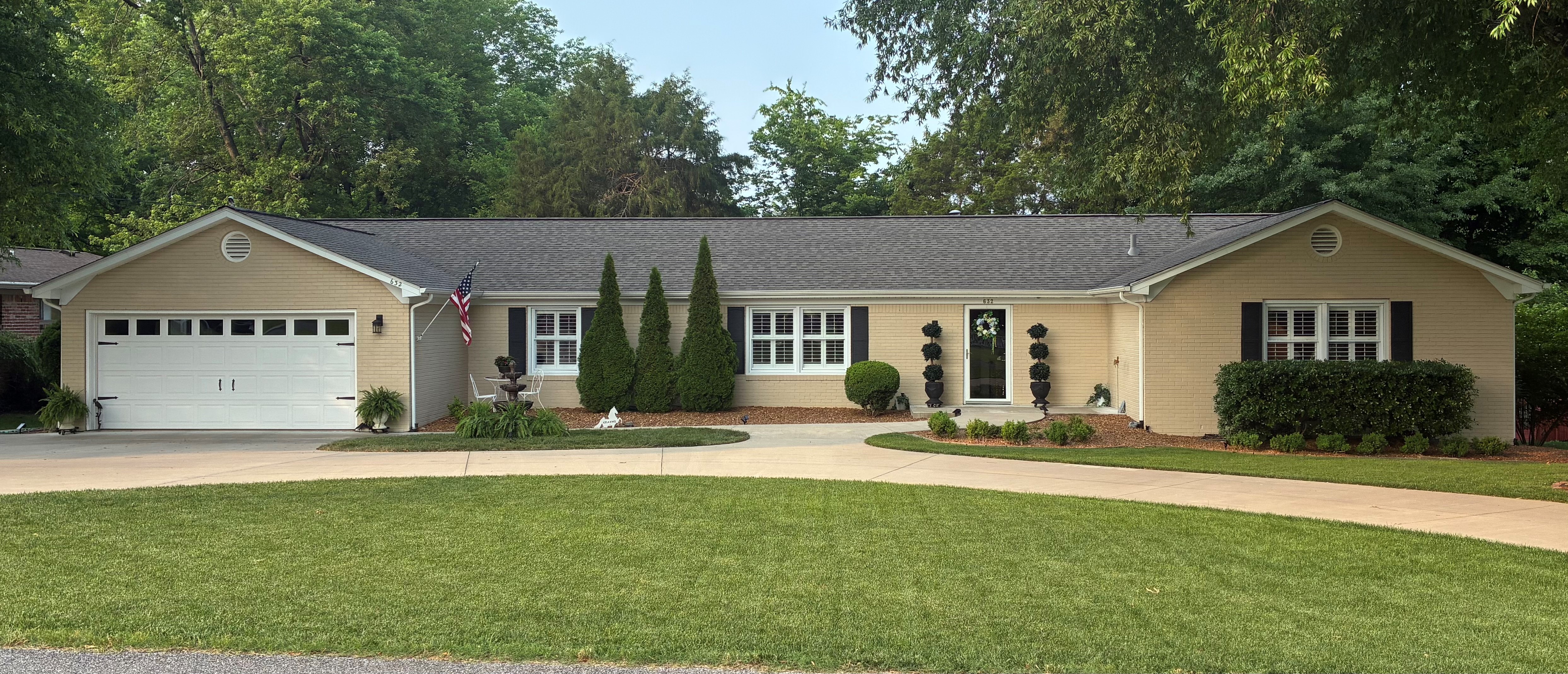 sprawling ranch-style home with circle front drive, tan brick
